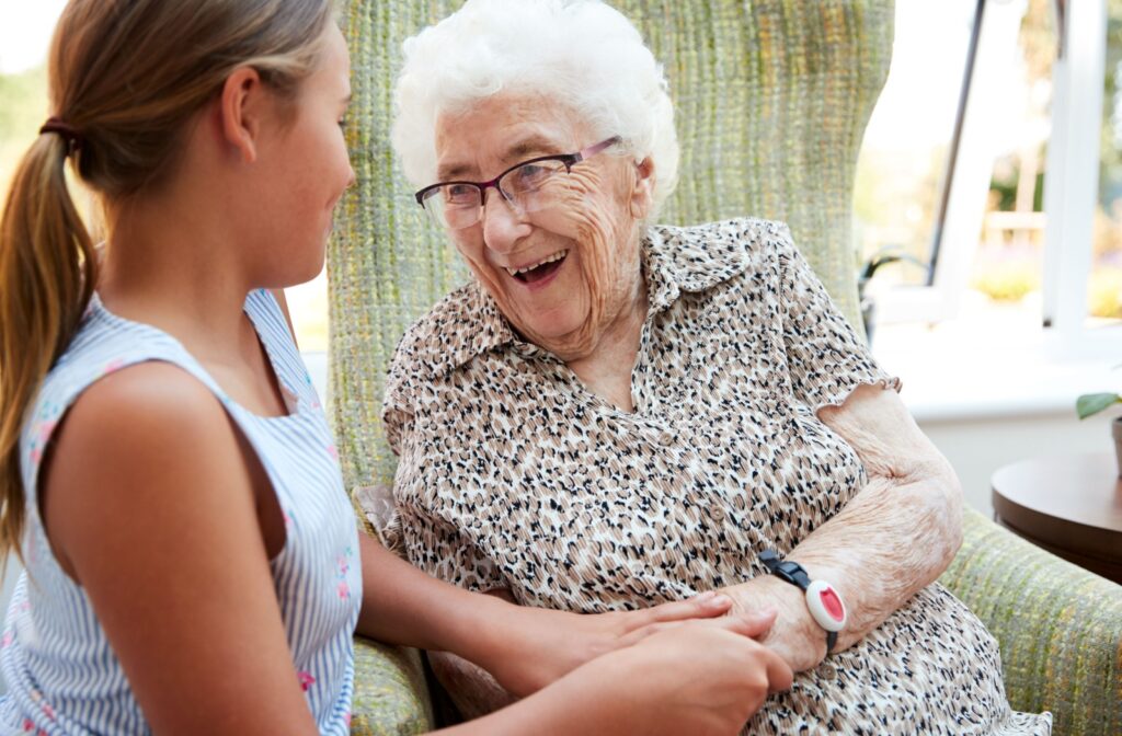 A young child visits their great-grandparent in a memory care community.